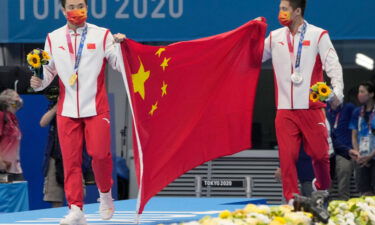 China's Cao Yuan (left) and Yang Jian celebrate their medals in the men's 10m platform final at the Tokyo Olympics.