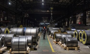 A worker walks past rolled steel products at Zaporizhstal