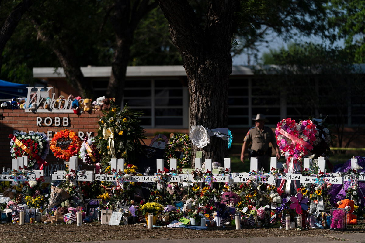 <i>Jae C. Hong/AP</i><br/>Flowers and candles are seen around crosses on May 28