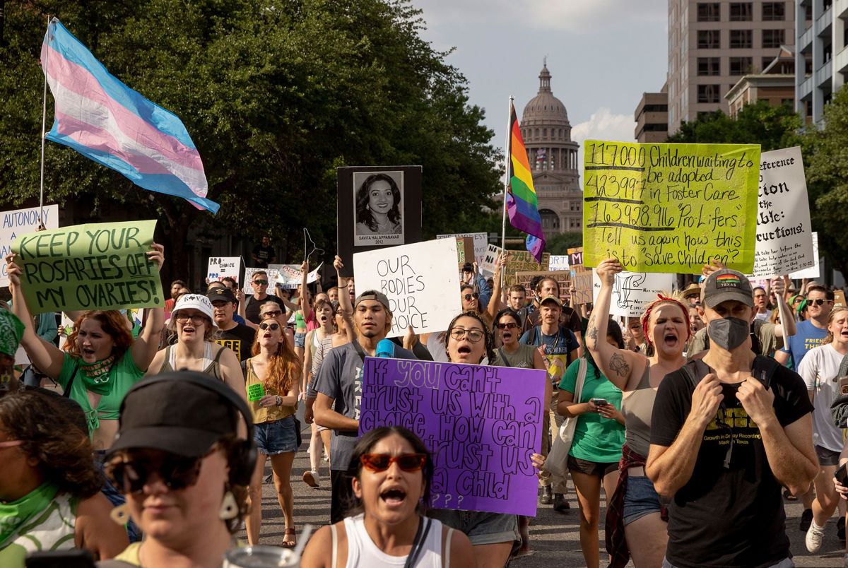 <i>Jay Janner/Austin American-Statesman/AP</i><br/>Protesters march from the Capitol to the United States Federal Courthouse to rally for abortion rights in Austin