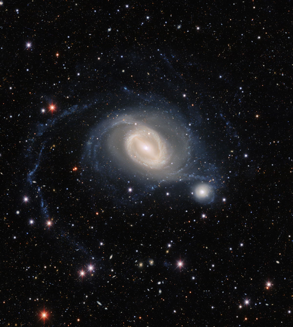 <i>NOIRLab/Dark Energy Survey</i><br/>A stunning 'galactic ballet' was captured in new telescope image. Galaxies NGC 1512 (left) and NGC 1510 swirl together in a dance that will eventually bring them together in this new image from the Dark Energy Camera.