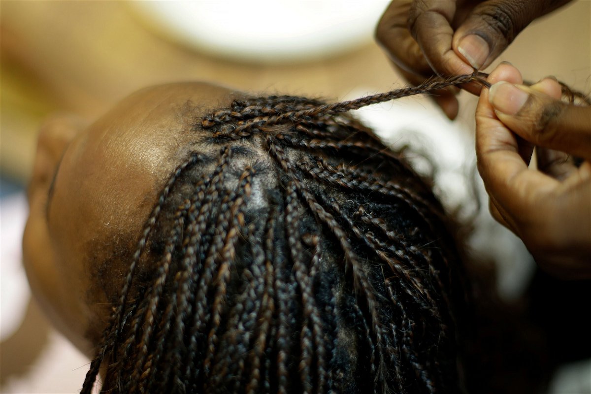 <i>Charlie Riedel/AP</i><br/>Shelly Smith braids hair at her salon