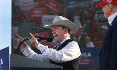 Former President Donald Trump listens as Nebraska gubernatorial candidate Charles Herbster speaks during a rally at the I-80 Speedway on May 1 in Greenwood