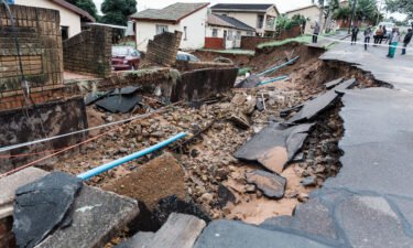 A severely damaged home and destroyed road following heavy rains and flooding in Durban
