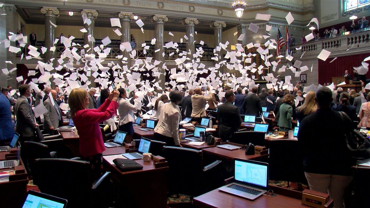 House lawmakers in Jefferson City, Mo. toss papers into the air as the session came to a close on Friday, May 13, 2022.