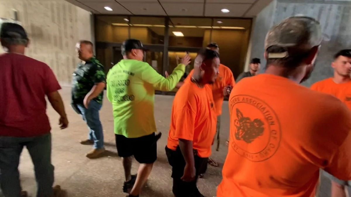 <i>KITV</i><br/>Members of the Pig Hunters Association of Oahu greet each other outside the DLNR.
