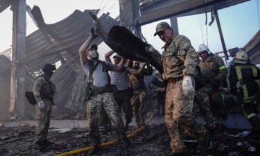 Rescuers work at a site of a shopping mall hit by a Russian missile strike
