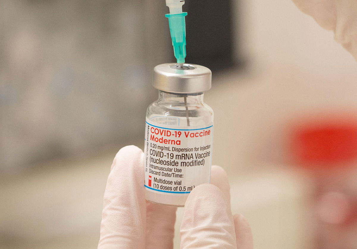 <i>Arnd Wiegmann/Reuters/File</i><br/>A healthcare worker fills up a syringe with a dose of Moderna's COVID-19 vaccine for a booster shot at the vaccination reference center at the Epidemiology