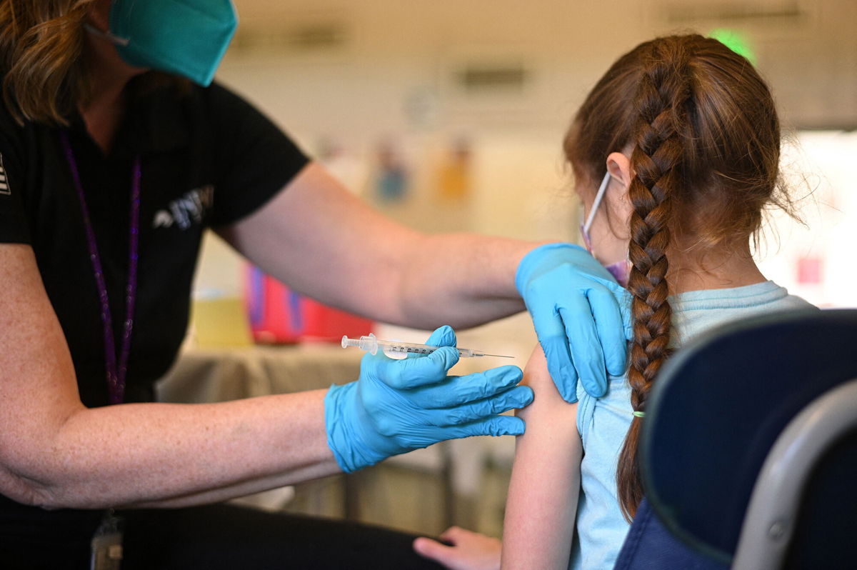 <i>Robyn Beck/AFP/Getty Images</i><br/>A nurse administers a pediatric dose of the Covid-19 vaccine to a girl at a L.A. Care Health Plan vaccination clinic at Los Angeles Mission College in the Sylmar neighborhood in Los Angeles