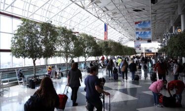 Passengers walk between terminals at Charlotte Douglas International Airport on May 15
