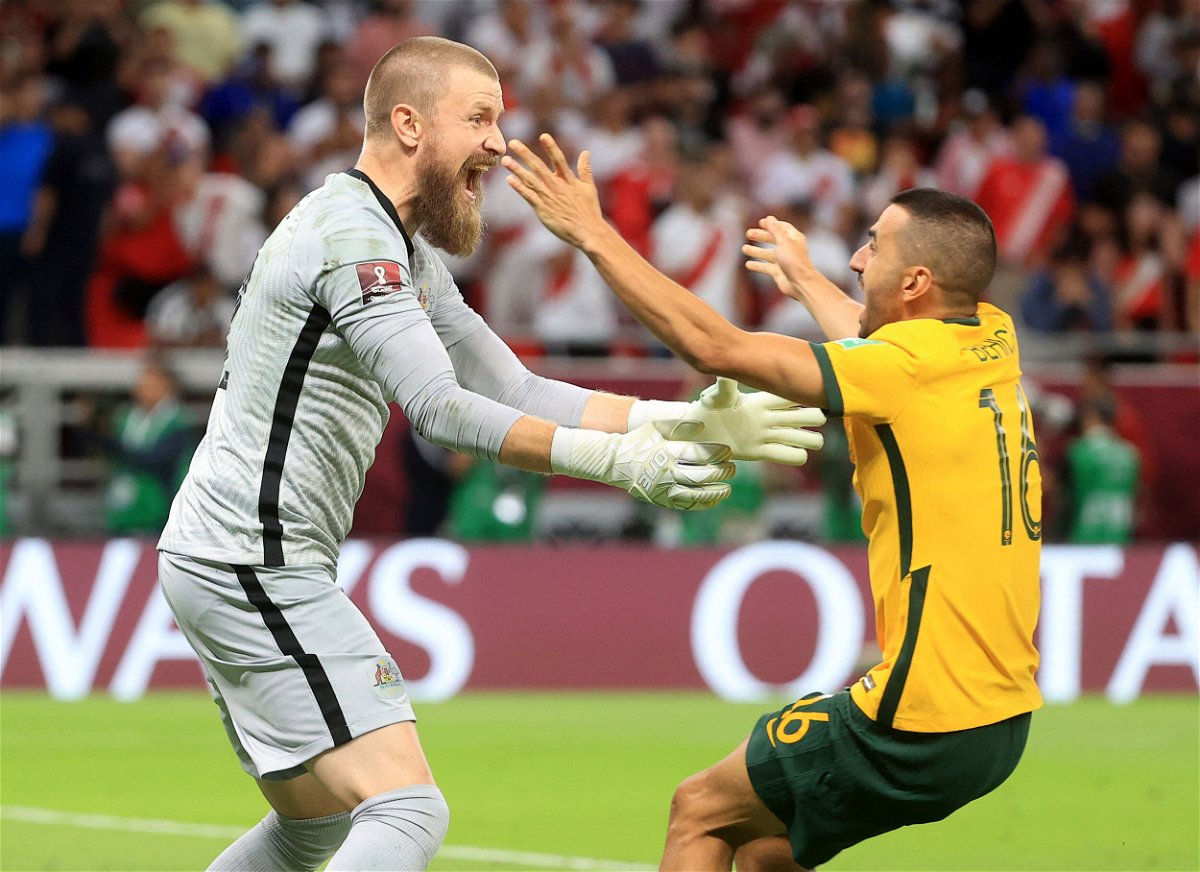 <i>Mohammed Dabbous/Reuters</i><br/>Australia's Andrew Redmayne and teammate Aziz Behich celebrate after qualifying for the FIFA World Cup on June 13.