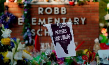 A banner hangs at a memorial outside Robb Elementary School to honor the victims killed in last week's school shooting