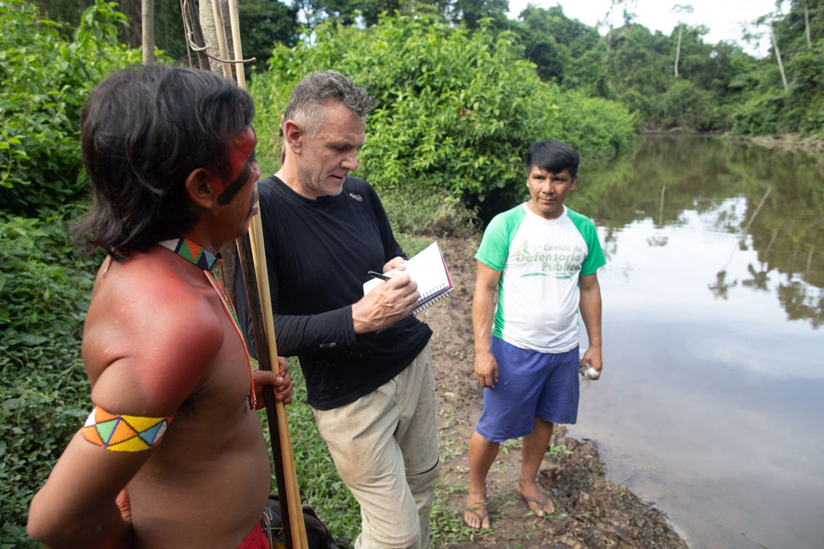 <i>Joao Laet/AFP/Getty Images</i><br/>Brazilian authorities said on June 16 that a suspect had confessed to killing Dom Phillips and Bruno Pereira. Phillips (C) is pictured talking to two indigenous men in Aldeia Maloca Papiú