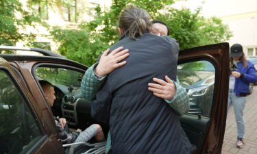 Reverend Grigory Mikhnov-Vaytenko hugs Shishkina