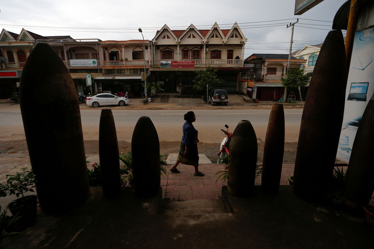 <i>Jorge Silva/Reuters</i><br/>How a new library sheds light on the US 'secret war' in Laos. A woman is seen walking past a restaurant littered with unexploded bombs dropped by US Air Force planes during the Vietnam War