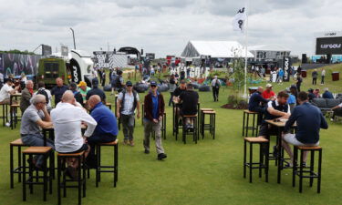 Specators enjoy the fan zone ahead of the start of the inaugural LIV Golf event.