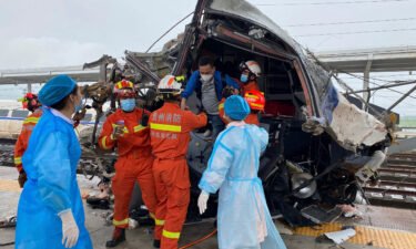 Emergency personnel help a passenger off a damaged train car after it derailed in Rongjiang County in southwestern China's Guizhou Province