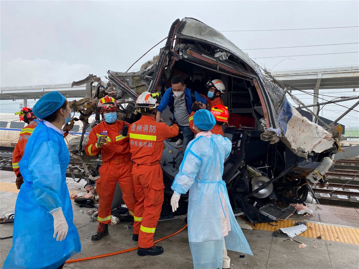 <i>Xinhua/AP</i><br/>Emergency personnel help a passenger off a damaged train car after it derailed in Rongjiang County in southwestern China's Guizhou Province