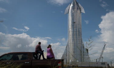 Space enthusiasts look at a prototype of SpaceX's Starship spacecraft at the company's Texas launch facility on September 28