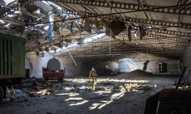 A Ukrainian army officer inspects a grain warehouse in Kherson region after it was shelled by Russian forces on May 6.