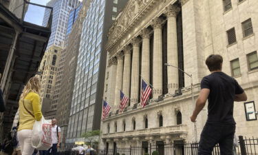 Pedestrians walk by the New York Stock Exchange