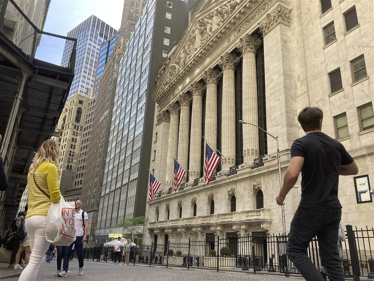 <i>Peter Morgan/AP</i><br/>Pedestrians walk by the New York Stock Exchange