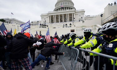 Violent insurrectionists loyal to then-President Donald Trump break through a police barrier at the Capitol in Washington on January 6