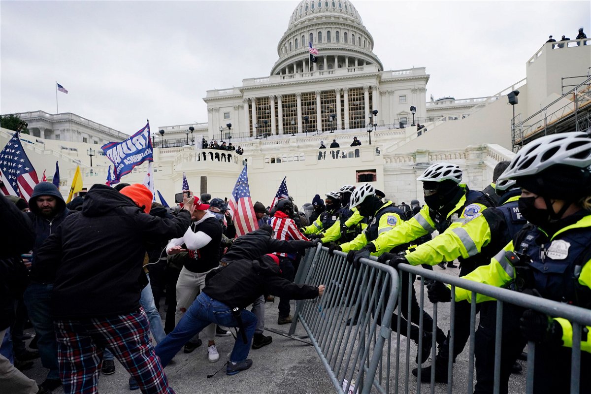 <i>Julio Cortez/AP</i><br/>Violent insurrectionists loyal to then-President Donald Trump break through a police barrier at the Capitol in Washington on January 6