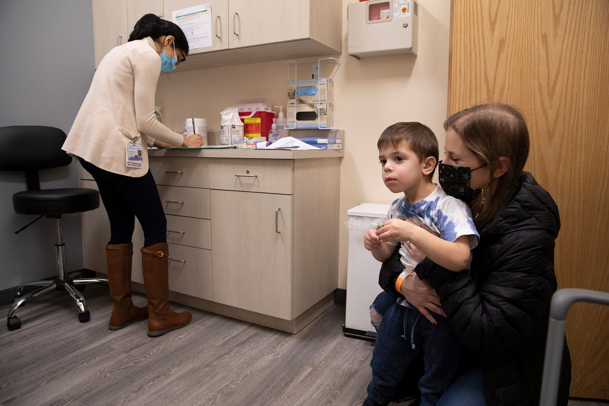 <i>Emma H. Tobin/AP</i><br/>Ilana Diener holds her son