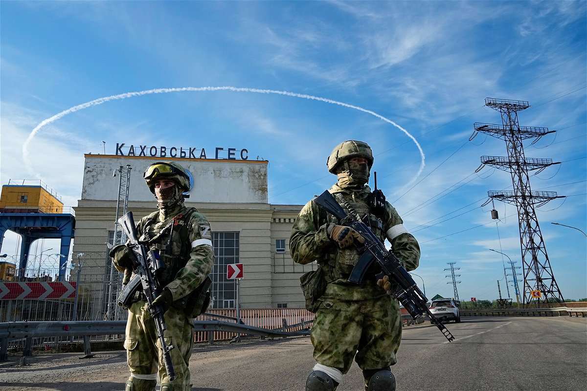 <i>AP</i><br/>Russian troops guard an entrance of the Kakhovka Hydroelectric Station