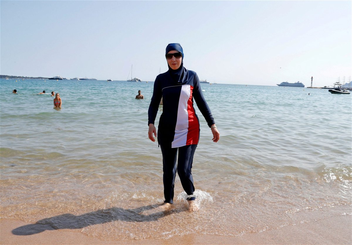 <i>Eric Gaillard/File/Reuters</i><br/>A woman wearing a burkini walks on a beach in Cannes