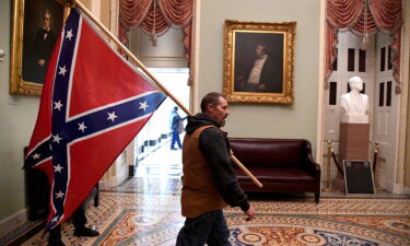 Kevin Seefried carries a Confederate battle flag on the second floor of the U.S. Capitol on January 6
