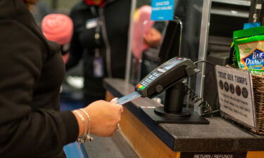 An air traveler uses a credit card to pay for items January 28