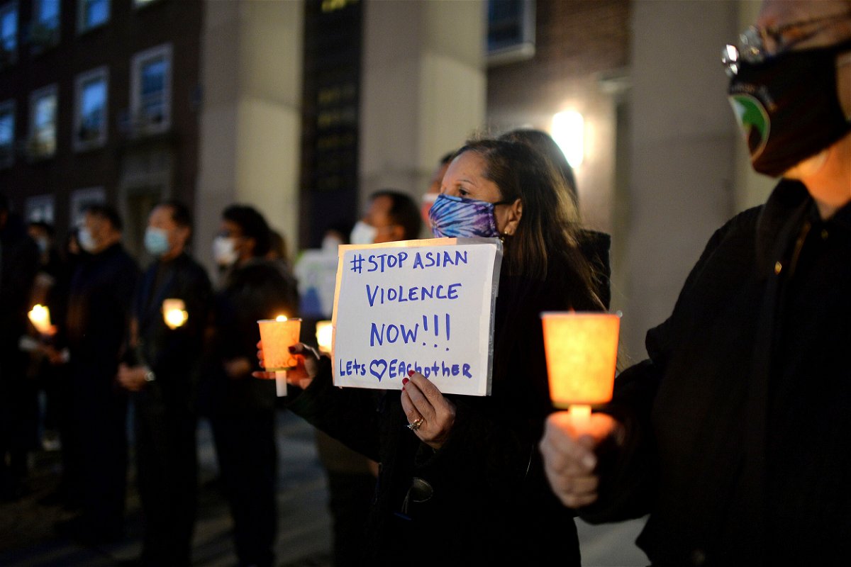 <i>Anthony Behar/SIPA USA/AP</i><br/>People attend a candlelight vigil in New York in 2021 after the Atlanta spa shootings. A new report shows only 7 of 233 reported attacks against Asian Americans in NYC in 2021 led to hate crime convictions.