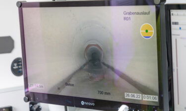 The movement of a robot through the sewer system can be seen on a monitor.