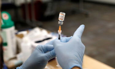 Nurse practitioner Sarah Rauner fills a syringe with the Pfizer Covid-19 vaccine to be administered to children from 5-11 years old are seen at the Beaumont Health offices in Southfield