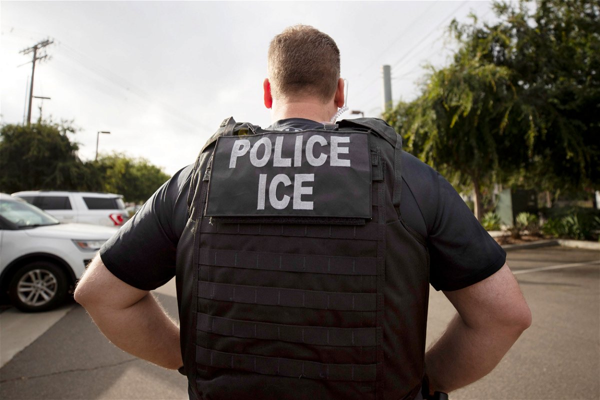<i>Gregory Bull/AP</i><br/>A US Immigration and Customs Enforcement officer looks on during an operation in Escondido