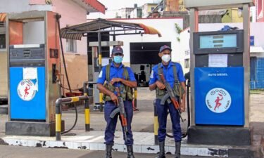 Naval officers guard a closed fuel station in Colombo