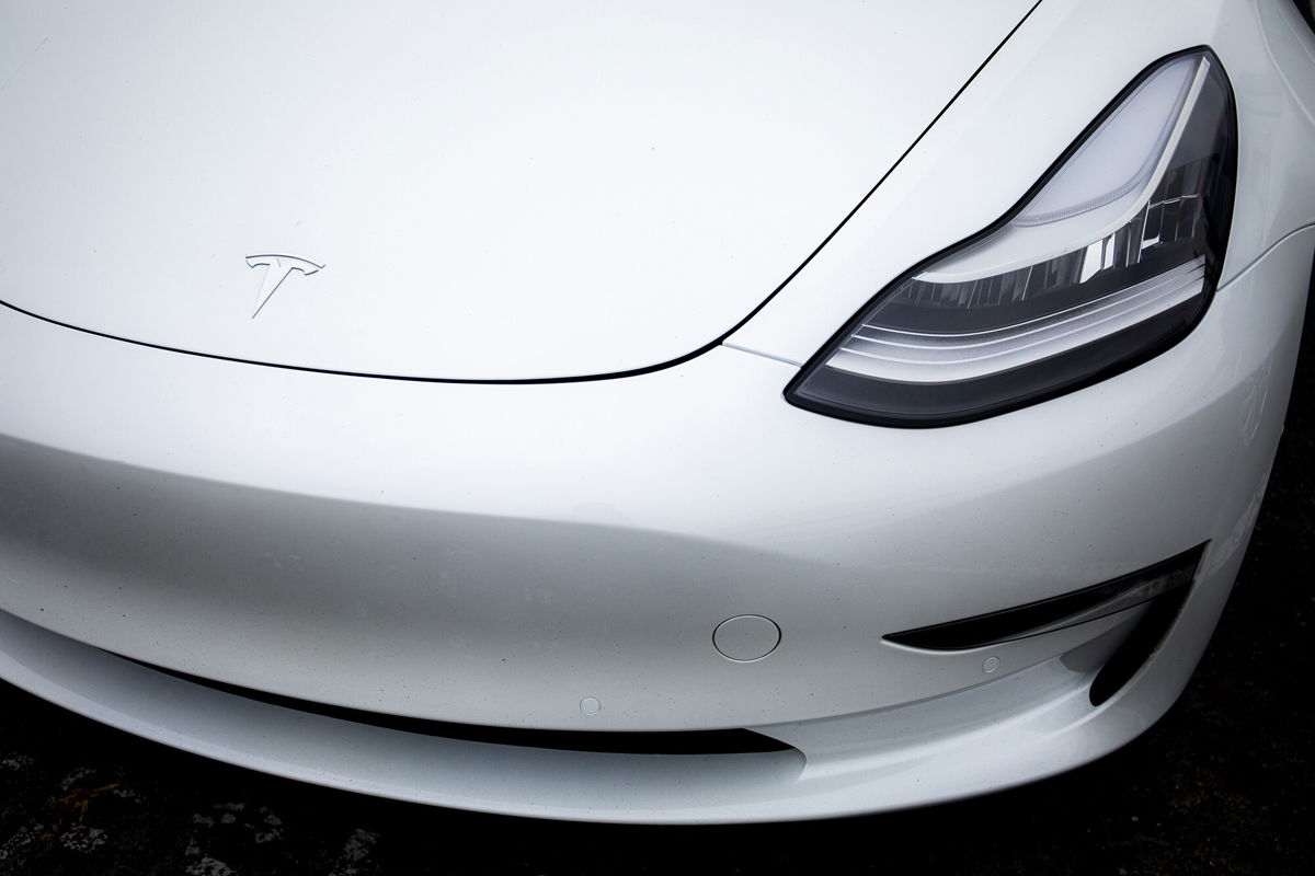 <i>Nina Riggio/Bloomberg/Getty Images</i><br/>A logo is displayed on a Tesla Inc. electric vehicle charging at the Tesla Supercharger station in Fremont