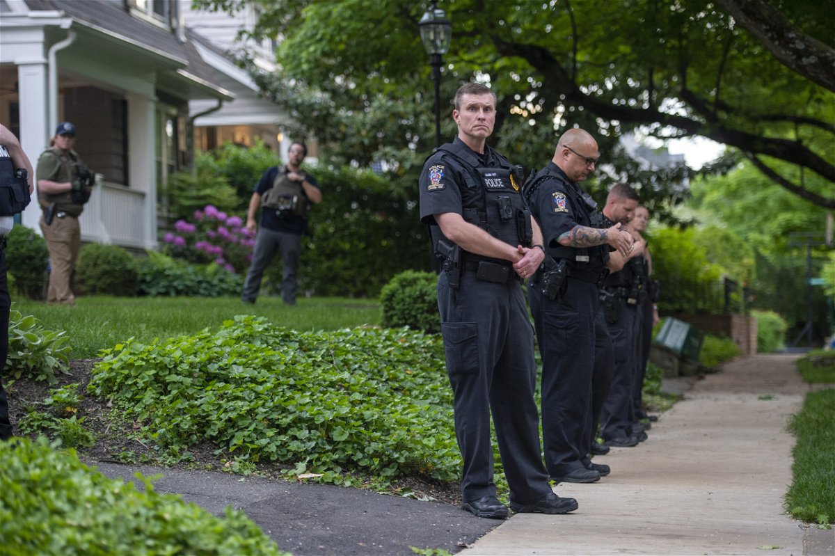 <i>Bonnie Cash/Getty Images</i><br/>Police officers stand outside the home of US Supreme Court Justice Brett Kavanaugh in anticipation of an abortion-rights demonstration on May 18