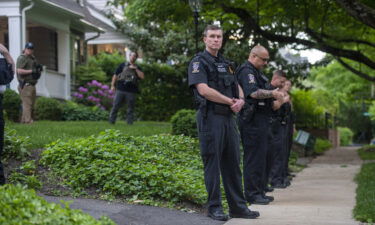 Police officers stand outside the home of Supreme Court Justice Brett Kavanaugh on May 18 in Chevy Chase