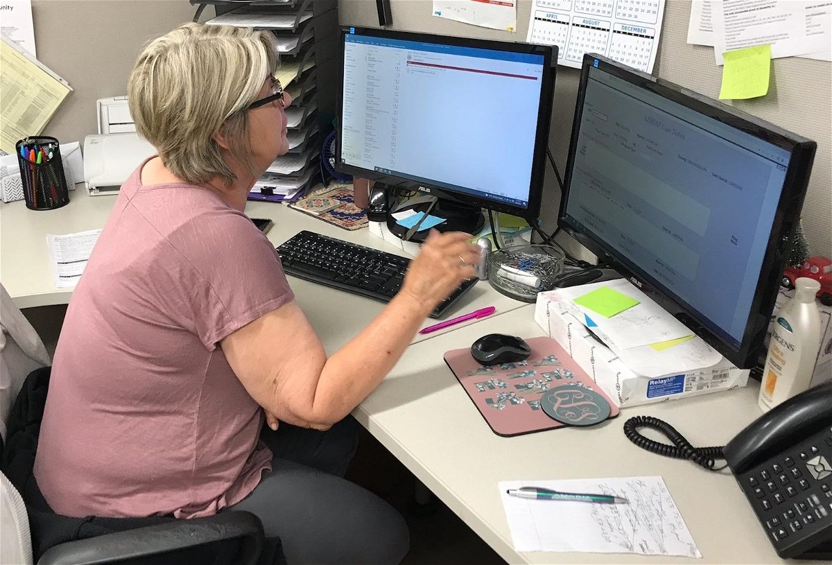 NECAC’s Cindy Lake processes a summer utility assistance application.