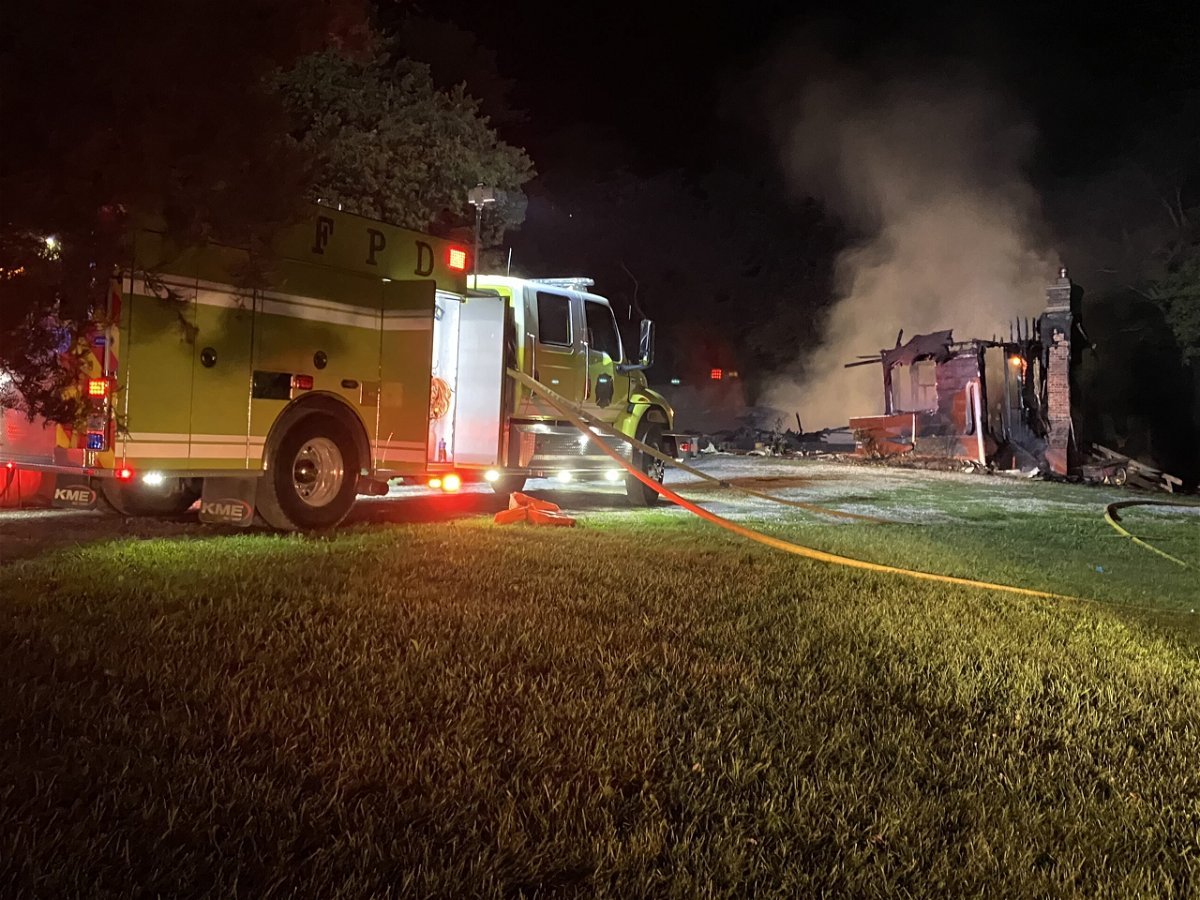 Johnson County firefighters work at the scene of a house fire on Sunday, June 20, 2022.