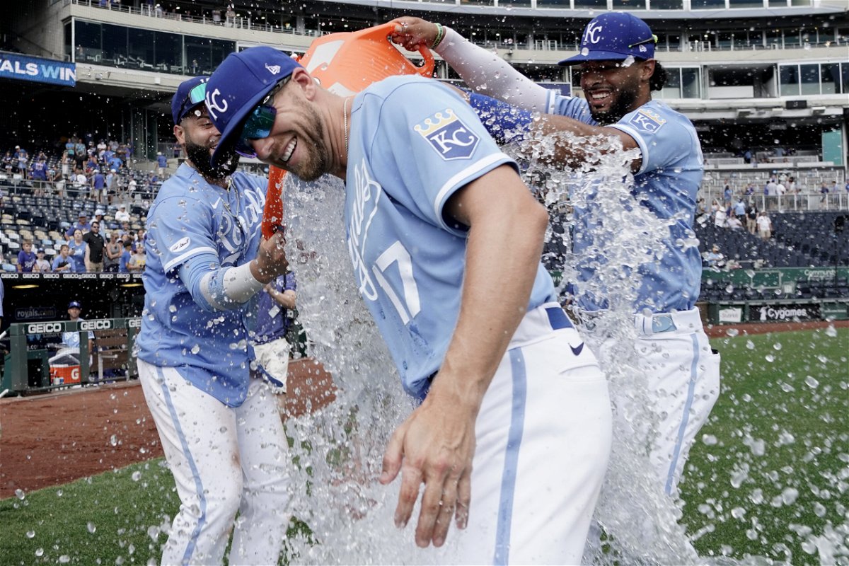 Kansas City Royals' Hunter Dozier (17) is doused with water by Emmanuel Rivera, left, and MJ Melendez as they celebrate a win over the Tampa Bay Rays during a baseball game Sunday, July 24, 2022, in Kansas City, Mo. 
