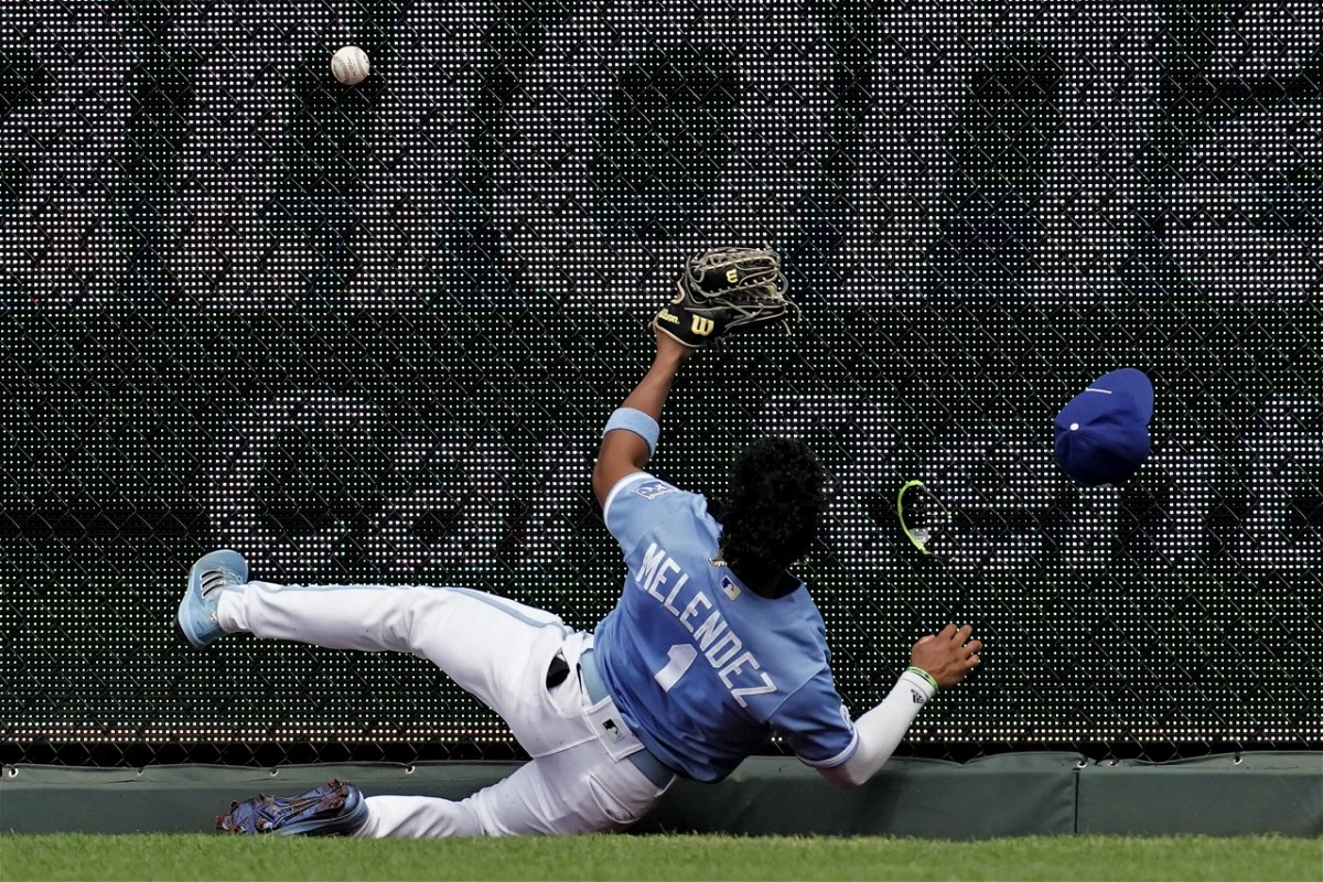 Kansas City Royals right fielder MJ Melendez hits the fence as he tries to catch an RBI triple hit by Los Angeles Angels' Phil Gosselin during the fifth inning of a baseball game Wednesday, July 27, 2022, in Kansas City, Mo. (AP Photo/Charlie Riedel)