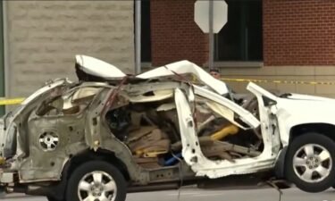 A vehicle explosion inside a parking garage that injured two people remains under investigation.