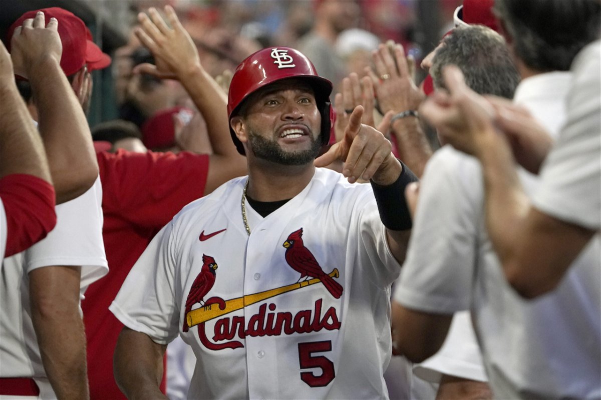 St. Louis Cardinals' Albert Pujols (5) is congratulated by teammates after scoring on a two-run home run by Corey Dickerson during the seventh inning of a baseball game against the Philadelphia Phillies Monday, July 11, 2022, in St. Louis. 
