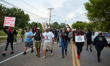 Demonstrators march after a vigil in honor of Jayland Walker on July 8