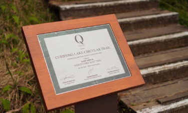 A plaque from QPI acknowledges the trail's achievement. The honor was given by a nonprofit to the the Cuifeng Lake Circular Trail in Taiwan.