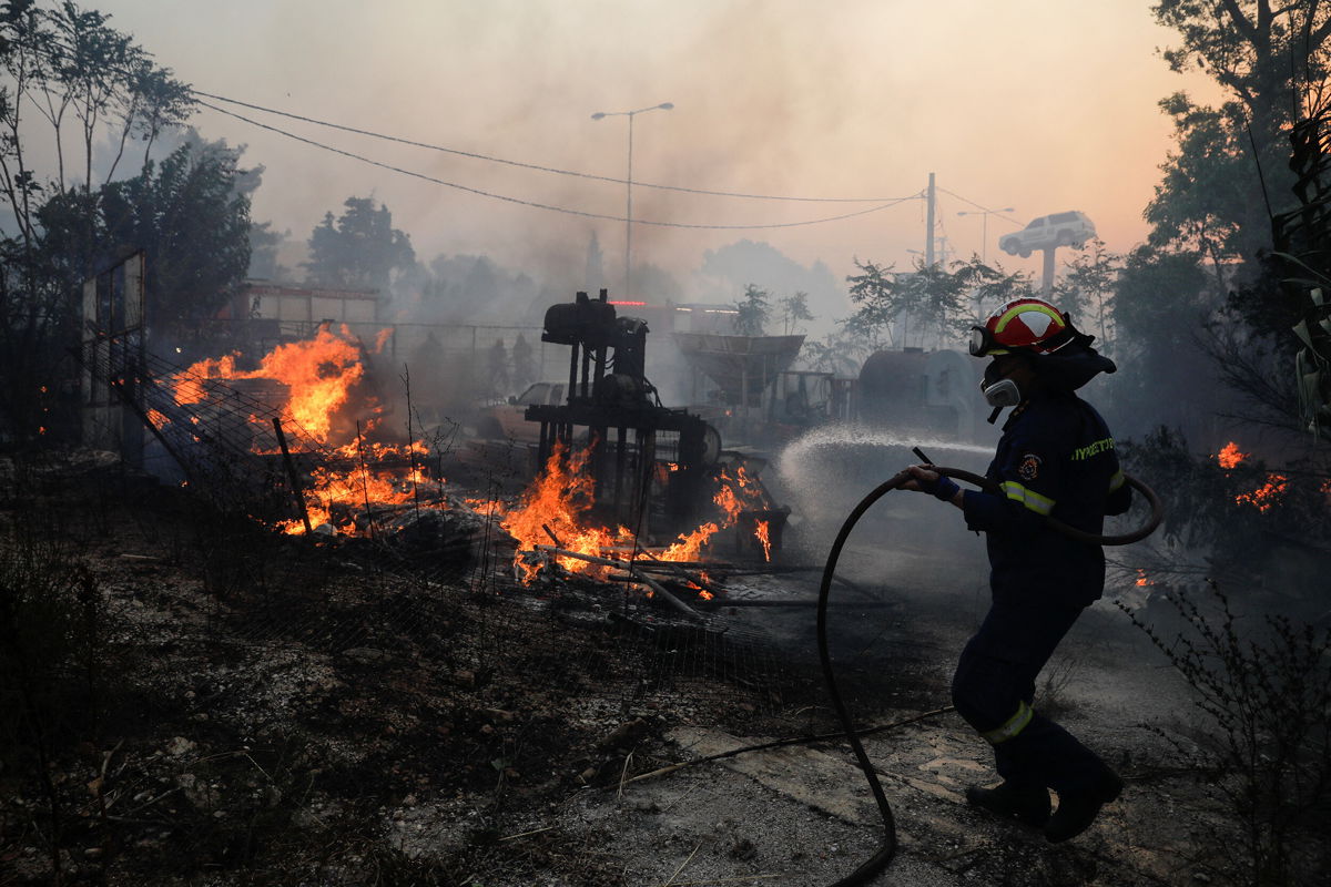 <i>Costas Baltas/Reuters</i><br/>A firefighter tries to extinguish a blaze in Pallini